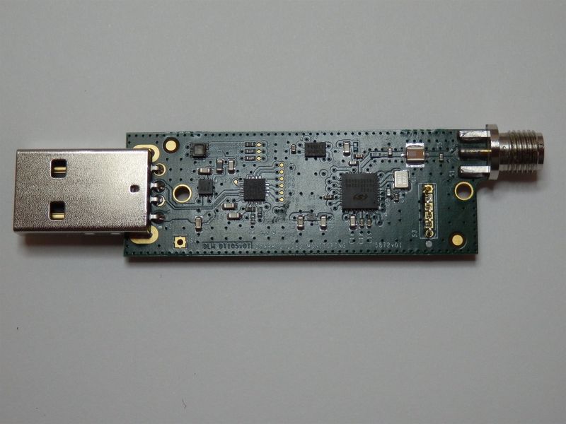 A USB radio dongle with an SMA antenna connector, designed by RF Logic